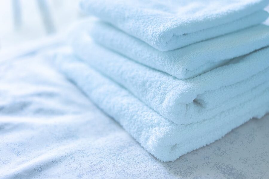 Stack of clean white folded hotel towels