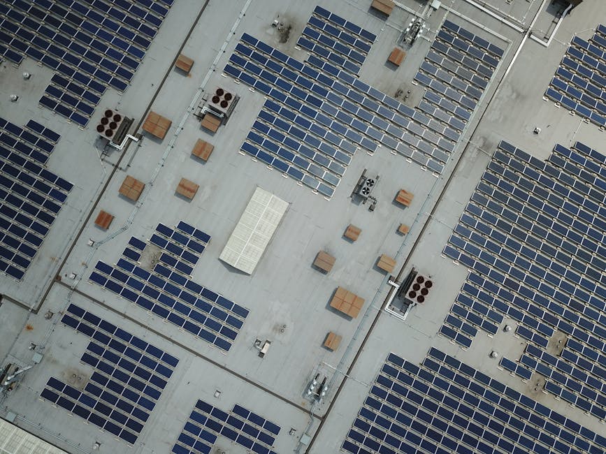 Aerial view of rooftop solar panels on a sustainable building