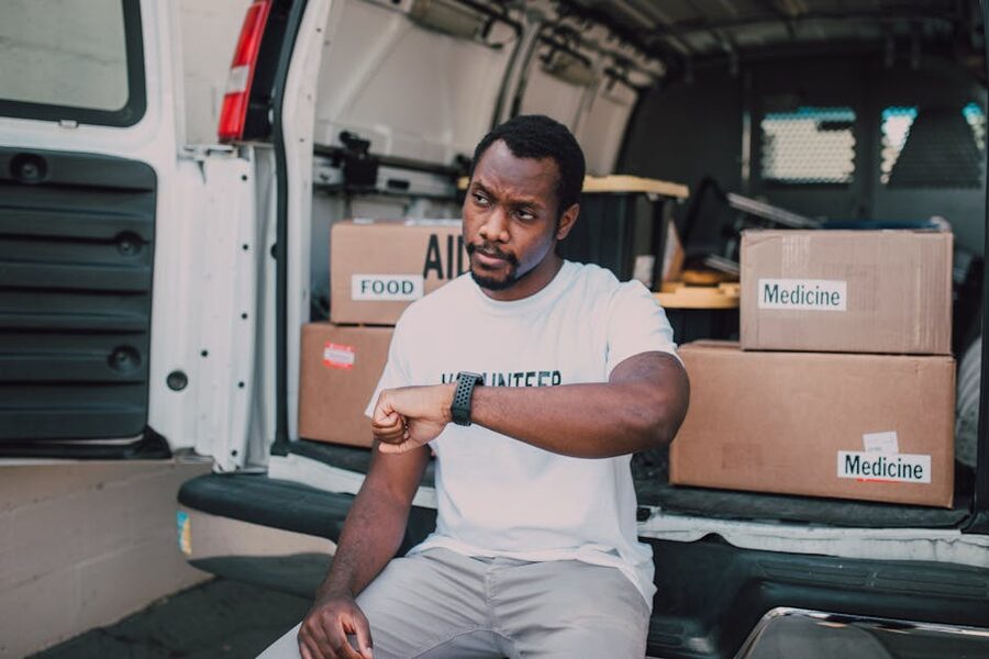 A volunteer organising aid deliveries from a van