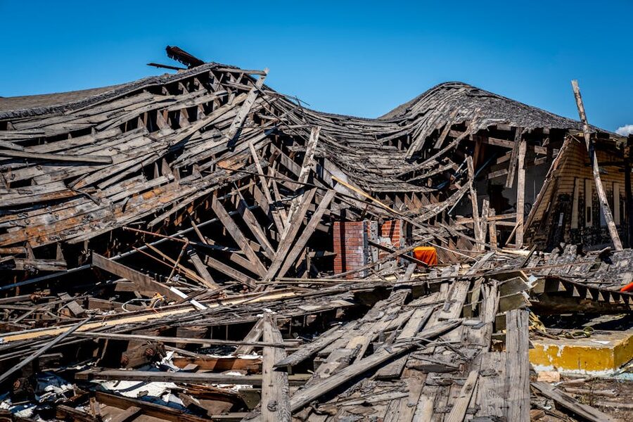 A destroyed wooden building after a natural disaster