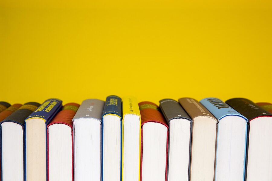 A stack of books and literature on a desk