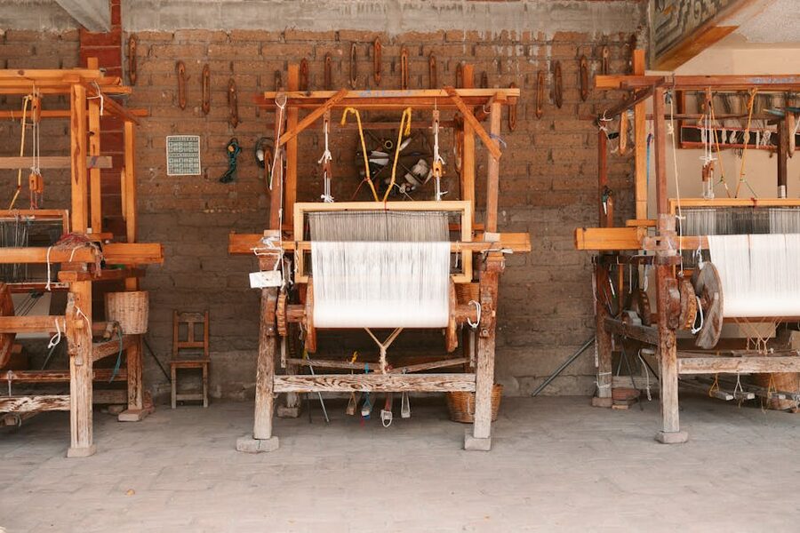 Three wooden looms in an Oaxaca artisan workshop