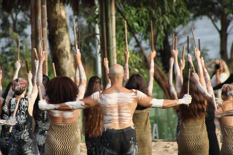Aboriginal dancers in traditional attire performing outdoors in Australia