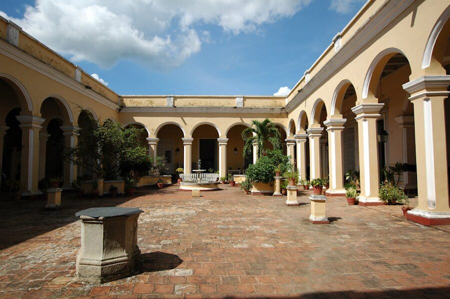 An old colonial courtyard with stone arches and plants in historic Cuba