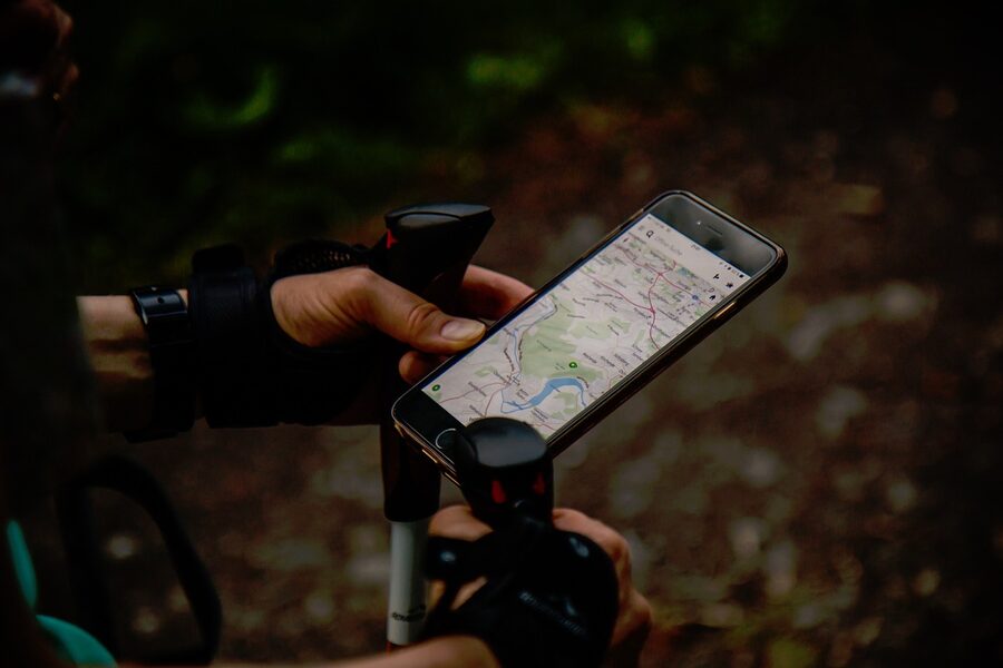 A traveller checking a map and phone to plan their route