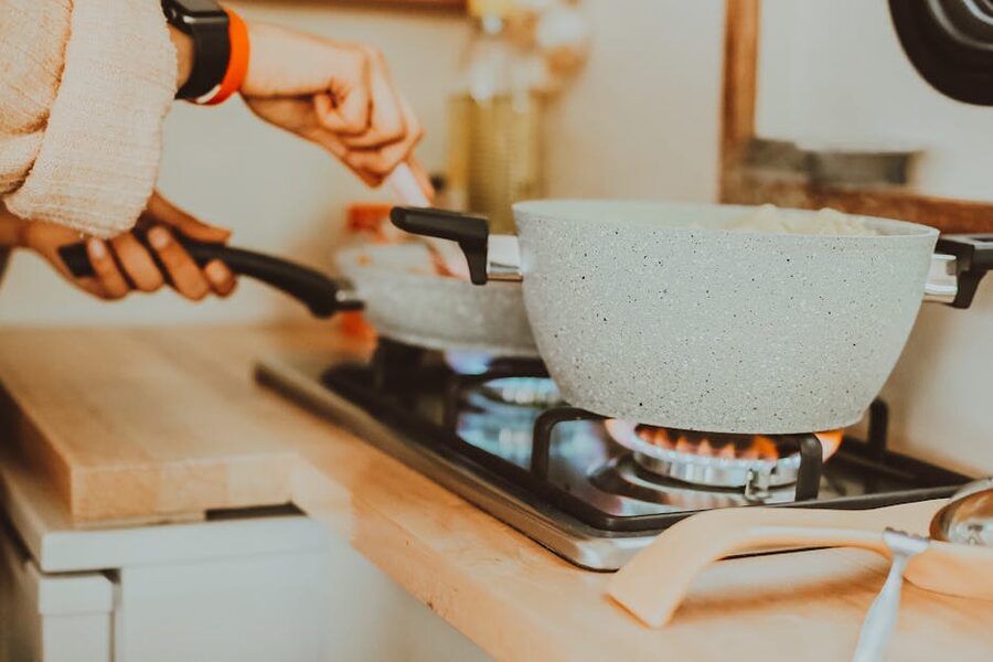 A pan on a gas stove with cooking utensils in a home kitchen in Istanbul